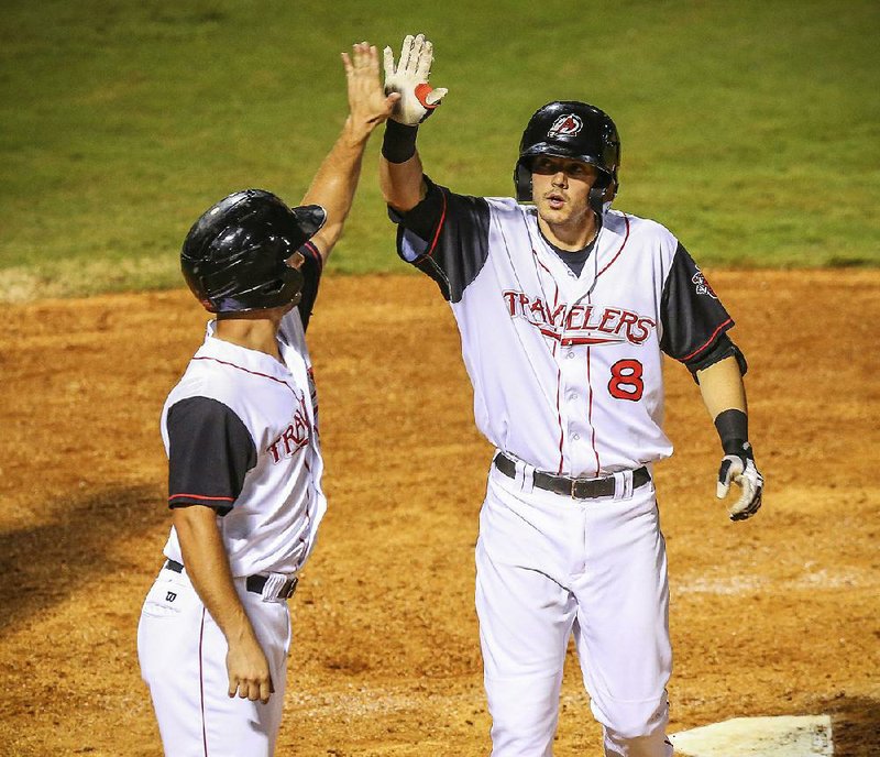 8/25/14
Arkansas Democrat-Gazette/STEPHEN B. THORNTON
Arkansas Travelers' Andrew Heid, left, High-5's Eric Stamets after Stamets 2-run homer brought them home in the third inning during their game Monday evening at Dickey-Stephens Park in North Little Rock.