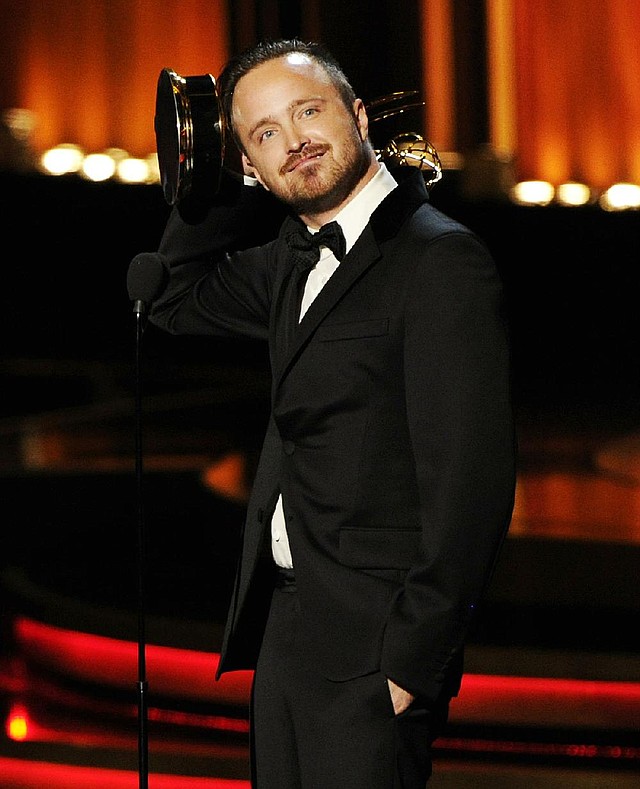 Aaron Paul accepts the award for outstanding supporting actor in a drama series for his work on “Breaking Bad” at the 66th Annual Primetime Emmy Awards at the Nokia Theatre L.A. Live on Monday, Aug. 25, 2014, in Los Angeles. (Photo by Chris Pizzello/Invision/AP)