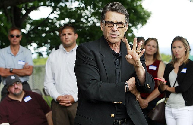 Texas Gov. Rick Perry speaks at a GOP picnic, Saturday, Aug. 23, 2014, in Chichester, N.H. It was Perry's second day visiting the nation's earliest presidential primary state as he considers another run for president.  (AP Photo/Jim Cole)