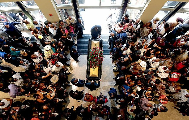 A casket containing the body of Michael Brown is wheeled out Monday, Aug. 25, 2014, at Friendly Temple Missionary Baptist Church in St. Louis. Hundreds of people gathered to say goodbye to Brown, who was shot and killed by a Ferguson, Mo., police officer on Aug. 9. (AP Photo/St. Louis Post Dispatch, Robert Cohen, Pool)