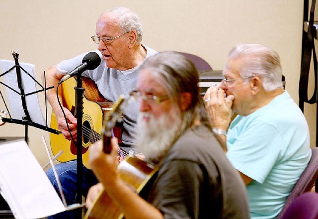 8/25/14
Arkansas Democrat-Gazette/STEPHEN B. THORNTON
Jay Richardson, left, sings as David Bacon, center, plays the guitar and Jim Taylor, right, on the harmonica, play together the 70's pop tune "Let Your Love Flow" during a weekly jam session at the Patrick Henry Hayes Senior Center in North LIttle Rock. 