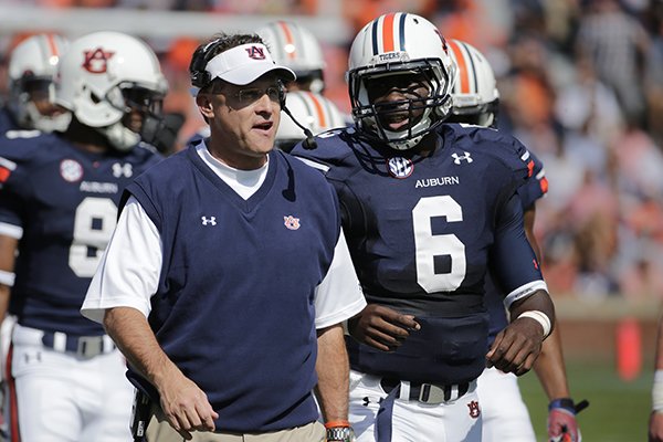 Auburn head coach Gus Malzahn talks with Auburn quarterback Jeremy Johnson (6) in the first half of an NCAA college football game in Auburn, Ala., Saturday, Oct. 12, 2013. (AP Photo/Dave Martin)