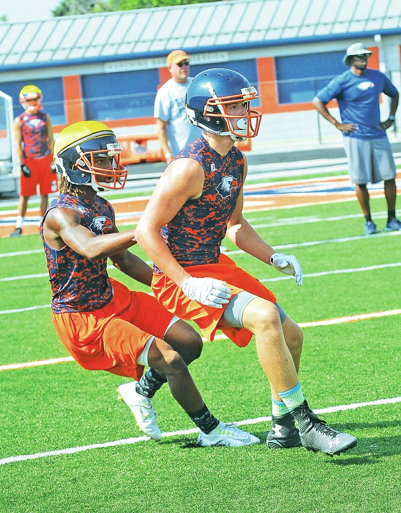 FILE PHOTO FLIP PUTTHOFF Collin Christian, right, goes through drills Aug. 5 with Rogers Heritage receivers during practice.