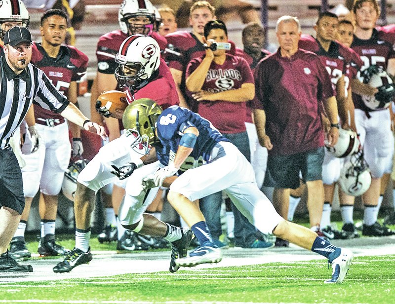 STAFF PHOTO ANTHONY REYES &#8226; @NWATONYR Zach Burton, left, Springdale High senior, is forced out of bounds Monday by Brennan Fulgham, Shiloh Christian sophomore, during a scrimmage at Bulldog Stadium in Springdale.