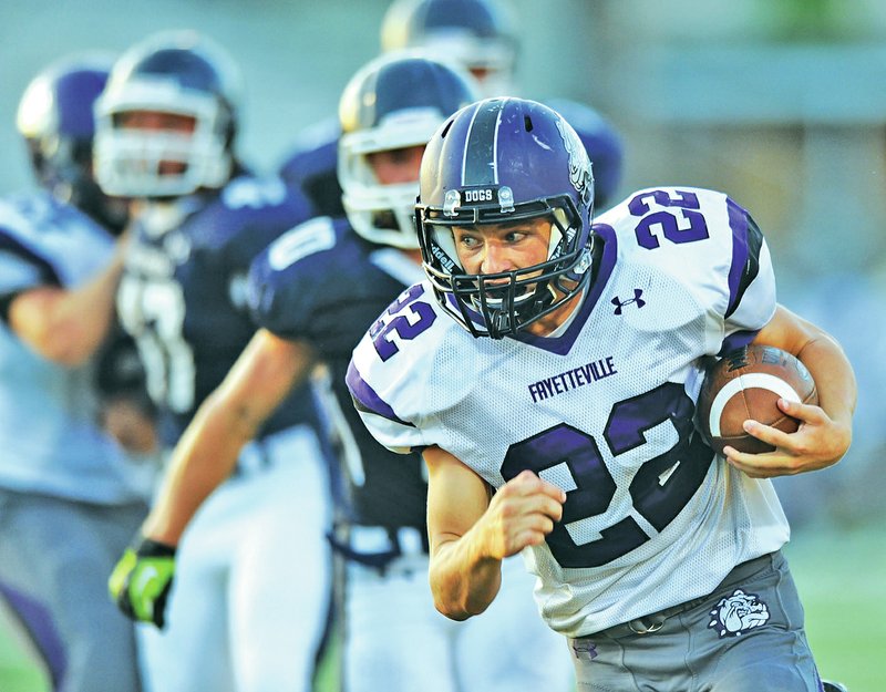 STAFF PHOTO ANDY SHUPE Luke Rapert, Fayetteville running back, carries the ball into the end zone Monday through the Greenwood defense during the second at Harmon Stadium in Fayetteville. Visit photos.nwaonline.com to see more photographs from the scrimmage.