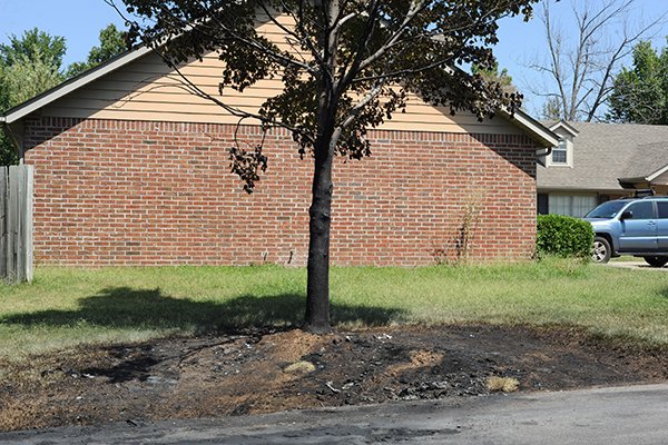 A burned spot marks the place where a truck belonging to University of Arkansas quarterback Brandon Allen was burned early Monday, Aug. 25, 2014, in Fayetteville.