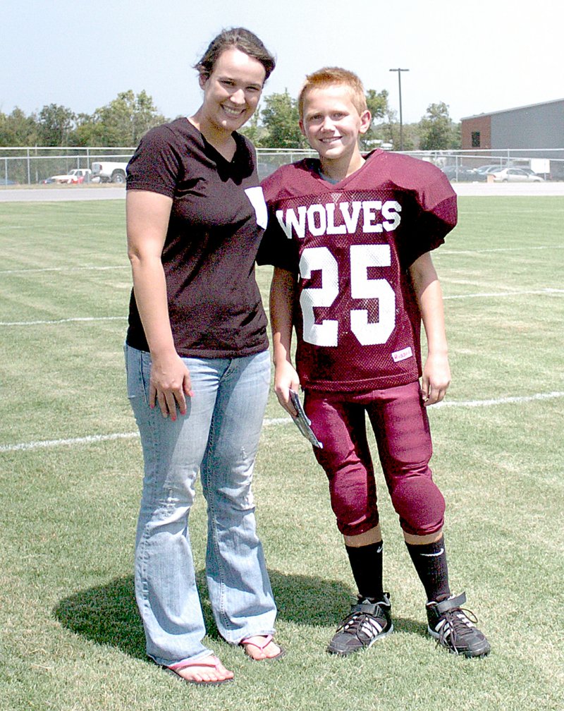 MARK HUMPHREY ENTERPRISE-LEADER Lincoln seventh grader Marcus Sturgill received support from his big sister Ashley on Friday. Marcus was busy getting ready for Media Day and Meet the Wolves and Ashley stepped up to help with his preparations.