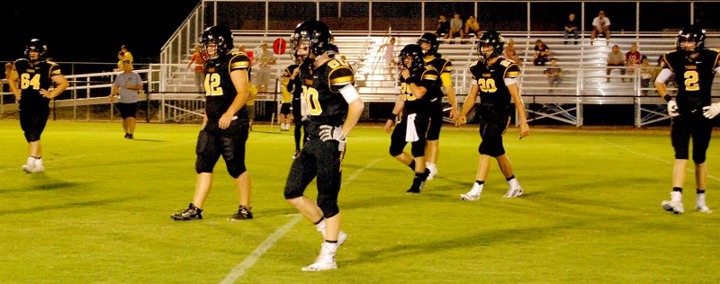 BEN MADRID ENTERPRISE-LEADER Prairie Grove&#8217;s senior Black defense takes the field awaiting the Gold offense during the annual Tiger intra-squad football scrimmage on Friday.