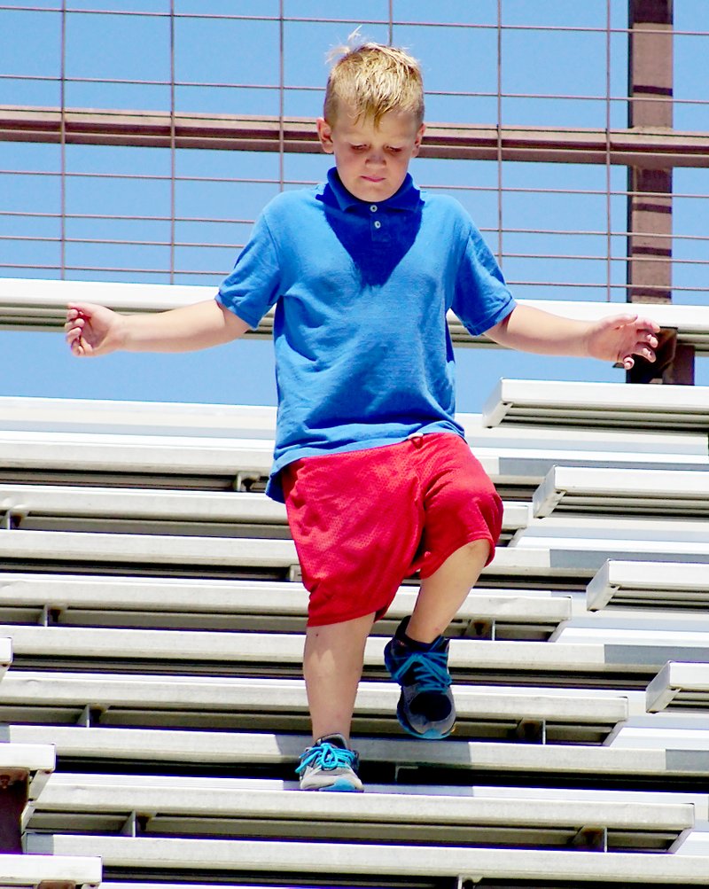 Photo by Randy Moll Unphased by the hot weather, Jeremiah Lemke, 8, along with brothers Isaiah and Eli, were getting in shape for football by running up and down the bleachers in Pioneer Stadium just before the start of school.