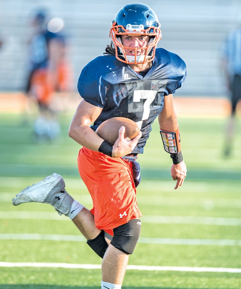  STAFF PHOTO ANTHONY REYES &#8226; @NWATONYR Joe Britton, Rogers Heritage sophomore, runs to the outside Tuesday against Van Buren during a scrimmage at Gates Stadium in Rogers.