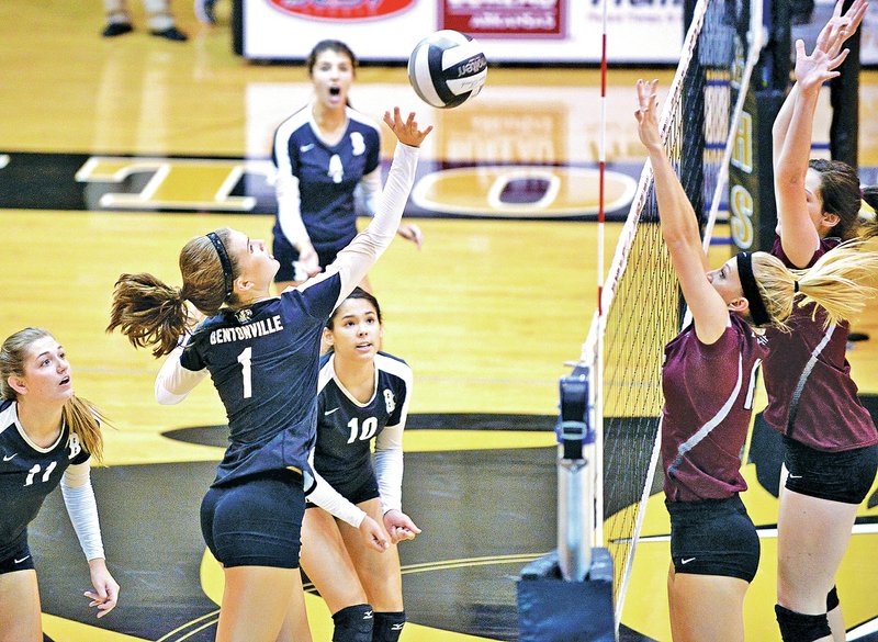 STAFF PHOTO BEN GOFF @NWABenGoff Emma Palasak, left, of Bentonville jumps to tip the ball over the net Tuesday as Siloam Springs&#8217;s Sierra Cifuentes and Baily Cameron jump to block during a nonconference match at Tiger Arena in Bentonville.