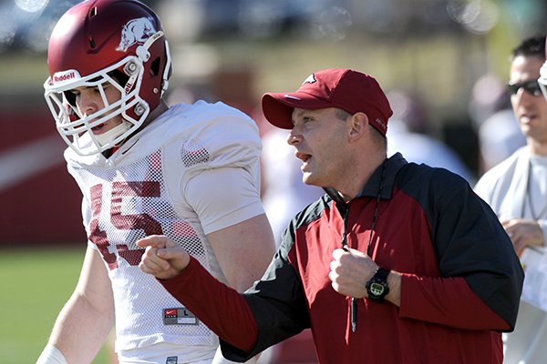 Arkansas defensive coordinator Robb Smith directs his players as linebacker Alex Brignoni (45) listens during practice Thursday, March 20, 2014, at the UA practice field in Fayetteville.