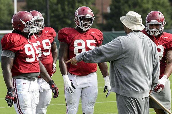 Alabama defensive line coach Bo Davis works with defensive linemen Darren Lake (95), Josh Frazier (69), Korren Kirven (85) and Brandon Ivory (99) as they go through drills during an NCAA college football practice Monday, Aug. 11, 2014, in Tuscaloosa, Ala. (AP Photo/AL.com, Vasha Hunt)