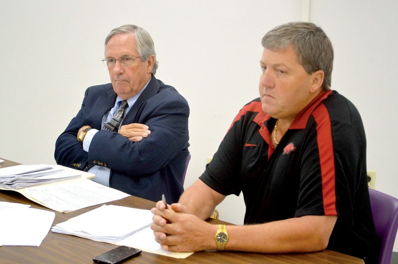 Former Mayflower High School Principal Jeff Cagle, right, is shown with his attorney, Randy Coleman of Little Rock, in September 2013 during Cagle’s termination hearing before the Mayflower School Board. The board unanimously upheld Superintendent John Gray’s recommendation to fire Cagle. Cagle filed a lawsuit against the district in November 2013 and was hired this summer by the Hazen School District as a math teacher. Gray said that through correspondence, Cagle asked for $40,000 and $5,000 in attorney’s fees.