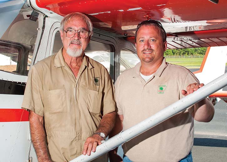 Pilot Phillip Rodgers, left, and Michael Sellers, aviation manager for the Arkansas Forestry Commission, stand by a Sesna T41, one of the planes used to spot fires around the state.