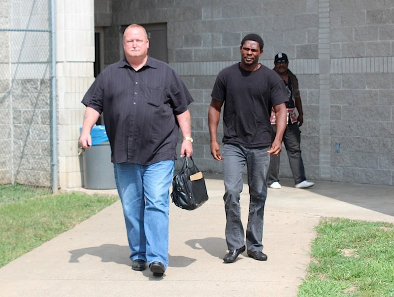 Former professional boxing champion Jermain Taylor (center) leaves the Pulaski County jail Wednesday morning with his bail bondsman (left). Taylor's bail had been set at $25,000 after he was charged with first-degree domestic battery and aggravated assault in the Tuesday shooting of his cousin.