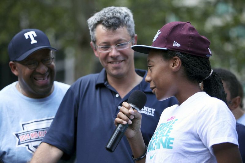 Pitcher Mo’ne Davis speaks to fans as Manager Alex Rice (middle) and Mayor Michael Nutter (far left) look on during a rally Sunday to welcome the team back to Philadelphia after competing in the Little League World Series.