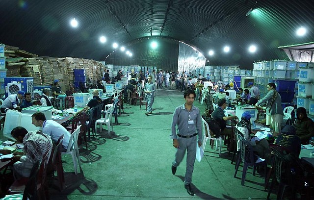 Afghan election workers sort ballots Wednesday in Kabul for an audit of runoff votes in the country’s troubled presidential election. Former Foreign Minister Abdullah Abdullah, saying the process is fraught with fraud, pulled his auditors from the recount Wednesday, and the other candidate, former Finance Minister Ashraf Ghani Ahmadzai, was asked to do likewise in the interest of fairness. Officials said the audit would proceed. 