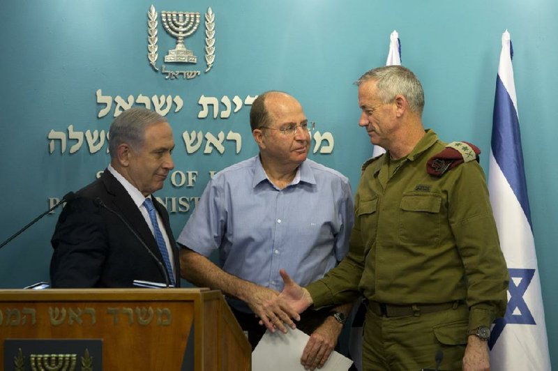 Israeli Prime Minister Benjamin Netanyahu (from left), Defense Minister Moshe Yaalon and Israeli Chief of Staff Lt. Gen. Benny Gantz appear at a news conference Wednesday in Jerusalem during which Netanyahu declared victory in the recent fighting in Gaza, saying “Hamas was hit hard” while Israel didn’t agree to any of Hamas’ demands. In Gaza, a Hamas spokesman claimed victory, saying the militant Palestinian group “forced the enemy to retreat.” 