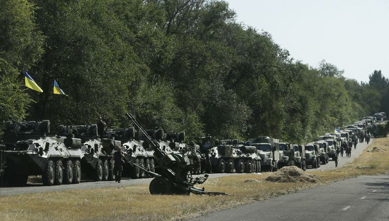 A column of Ukrainian armor and trucks waits for the signal to move on the town of Mariupol in eastern Ukraine, where experts say Russia is trying to open a new front in the fighting.
