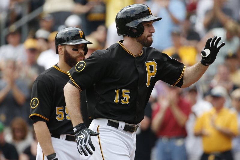 Pittsburgh Pirates' Ike Davis (15) celebrates as he returns to the dugout with teammate Russell Martin after hitting a two-run home run off St. Louis Cardinals' starting pitcher Adam Wainwright during the second inning of a baseball game in Pittsburgh Wednesday, Aug. 27, 2014.