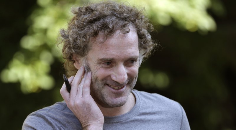 Peter Theo Curtis smiles as he talks with reporters outside his mother's home in Cambridge, Mass., Wednesday, Aug. 27, 2014.  Curtis, a freelance reporter who wrote under the byline Theo Padno and who had been held hostage for about two years in Syria, returned to the U.S. Tuesday.