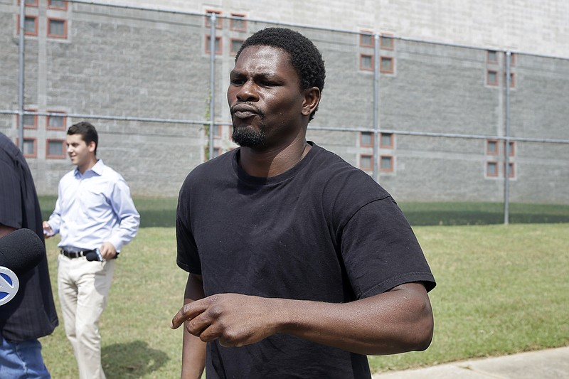 The Associated Press FREED ON BOND: Boxer Jermain Taylor walks from the Pulaski County Jail in Little Rock on Wednesday after spending the night there in connection with a shooting that wounded his cousin.