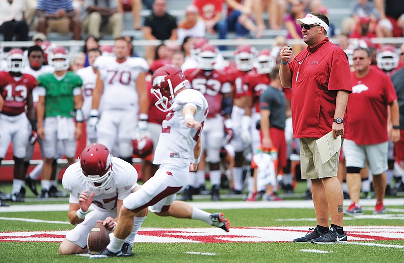 NWA Media/Andy Shupe WHISTLES WHILE HE WORKS: Arkansas coach Bret Bielema, here watching an open preseason at Reynolds Razorback Stadium in Fayetteville, expresses confidence in junior quarterback Brandon Allen going into Saturday’s season opener at Auburn. A 3 p.m. kickoff is scheduled on the new SEC Network (Resort Channel 79).