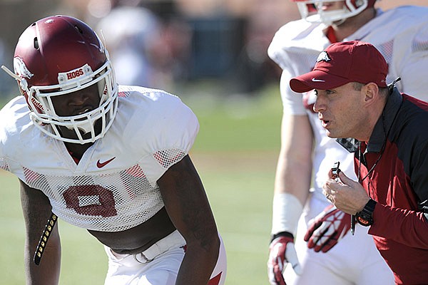 Arkansas defensive coordinator Robb Smith directs cornerback Will Hines (9) during practice Thursday, March 20, 2014, at the UA practice field in Fayetteville.