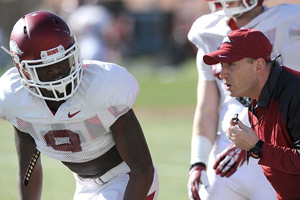 Arkansas defensive coordinator Robb Smith directs cornerback Will Hines (9) during practice Thursday, March 20, 2014, at the UA practice field in Fayetteville.