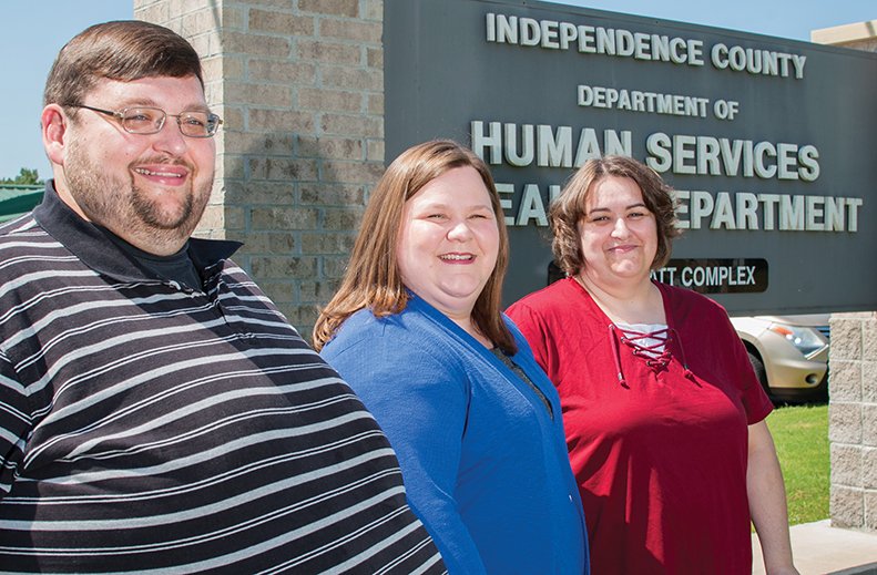 Charles Dean, president of the Independence County Foster and Adoptive Parents Association, from left, Vickey Dean, foster parent, and Erin Smith, Department of Human Services resource worker in Independence County, stand outside the DHS offices.
