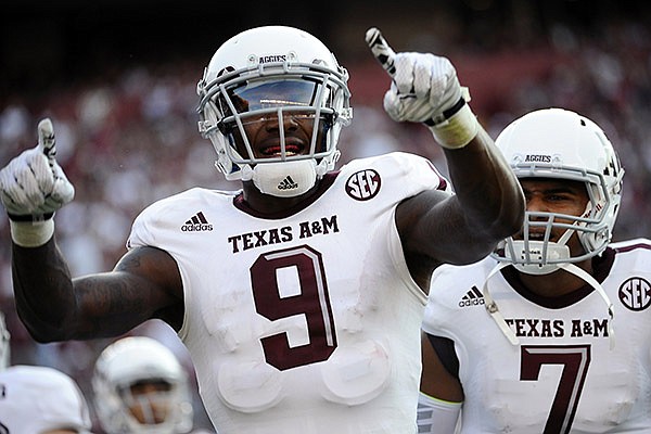 Texas A&M wide receiver Ricky Seals-Jones (9) celebrates with teammate Kenny Hill (7) after scoring a touchdown against South Carolina during the first half of an NCAA college football game on Thursday, Aug. 28, 2014, in Columbia, S.C. (AP Photo/Rainier Ehrhardt)