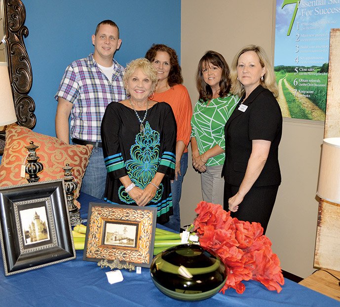 Standing with just a few of the silent-auction items for The Great Escape, a fundraiser for the Women’s Shelter of Central Arkansas in Conway, are board members Will Baker, from left, Michelle Nabholz, front, Susan Hilden, L.T. Clark and Annette Miller. The event, with the theme Come to Paris, will be held from 10 a.m. to 8 p.m. Friday and from 9 a.m. to 3 p.m. Saturday at the Conway Expo Center, 2505 E. Oak St. Admission is $10 and includes spa services, shopping, a fashion show and more.