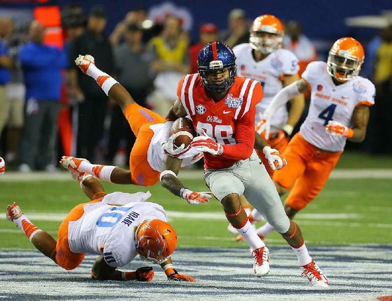 Mississippi receiver Cody Core runs past several Boise State defenders en route to a 76-yard touchdown during the Rebels’ 22-point victory at the Georgia Dome in Atlanta.