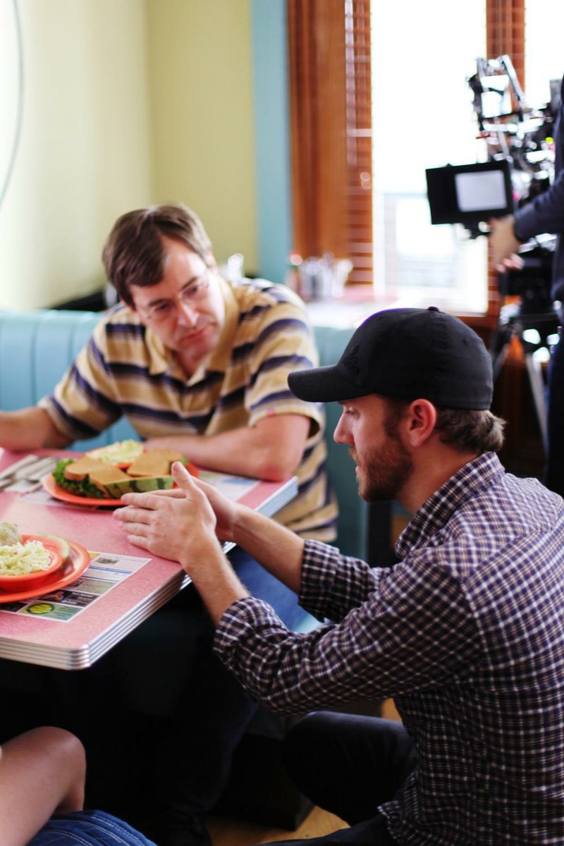 Director Charlie McDowell (in baseball cap) works with Mark Duplass on the set of The One I Love.