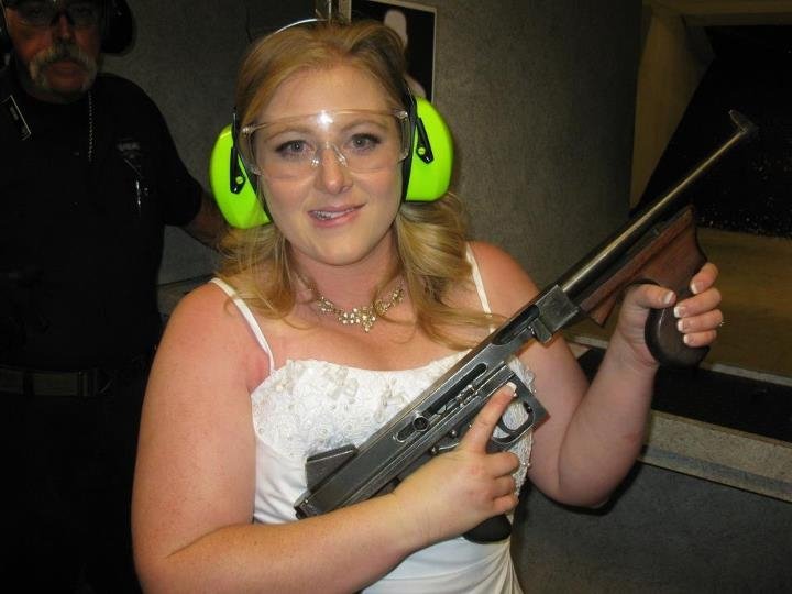 This July 28, 2012 file photo provided by Bob MacDuff shows Lindsae MacDuff holding an automatic weapon at the Gun store in Las Vegas after her "shotgun wedding." Tourists from Japan flock to ranges in Waikiki, Hawaii, and the dozen or so that have cropped up in Las Vegas offer bullet-riddled bachelor parties and literal shotgun weddings, where newly married couples can fire submachine gun rounds and pose with Uzis and ammo belts.