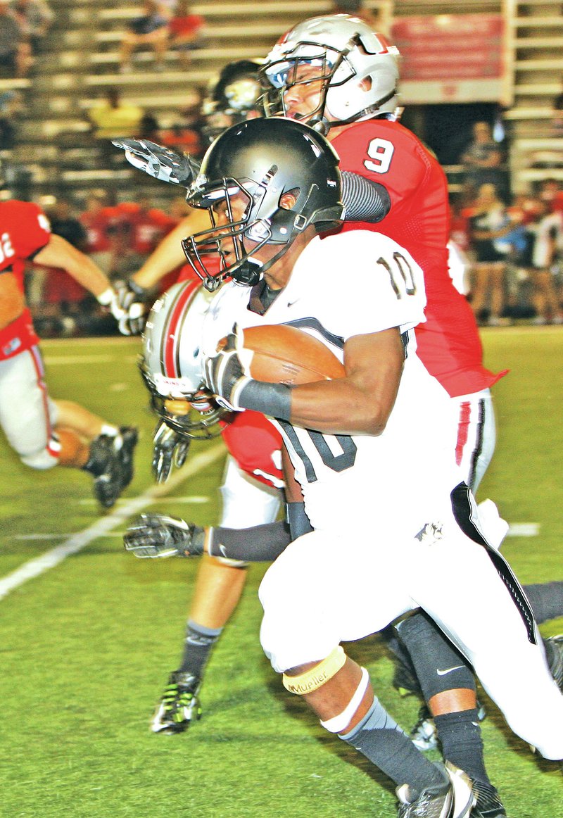 Special to NWA Media Joel Rafkin Kahill Gunn of Bentonville runs toward the sideline Thursday to gain yards and avoid the Union defense during the Gridiron Classic football preview at Tulsa Union High School in Oklahoma.