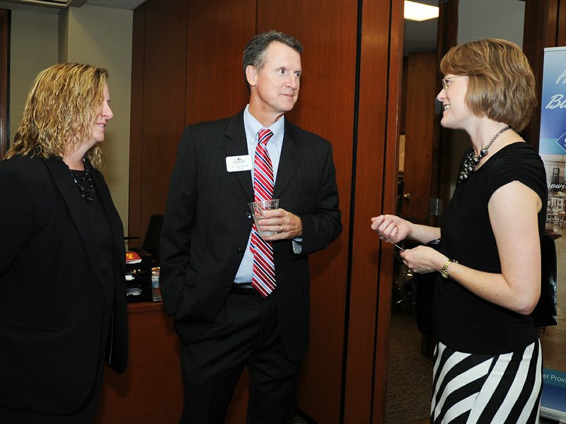 The Sentinel-Record/Mara Kuhn RECEPTION: National Park Community College President John Hogan, center, and his wife, Dorelle, right, visit with Angela Dugger, director of development at Mid-America Science Museum, during a &#8220;welcome event&#8221; for Hogan on Thursday at The Greater Hot Springs Chamber of Commerce.
