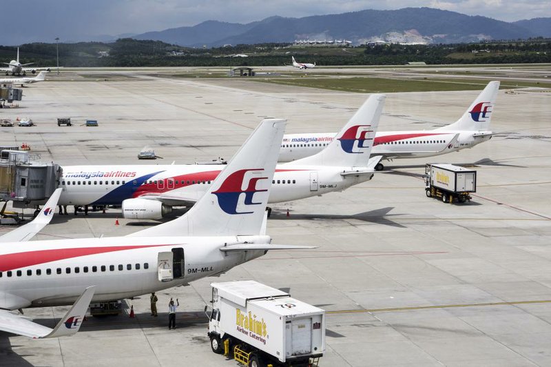 Aircraft operated by Malaysia Airlines sit Tuesday on the tarmac at Kuala Lumpur International Airport in Sepang, Malaysia.