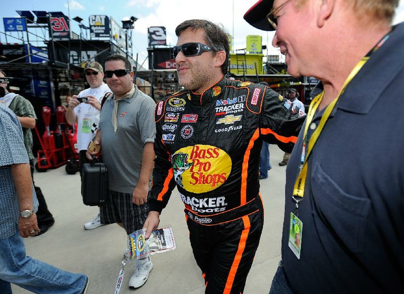 NASCAR driver Tony Stewart (center) returned Friday to Atlanta Motor Speedway and announced that he will race in Sunday’s Oral-B USA 500, three weeks after his car struck and killed driver Kevin Ward Jr.