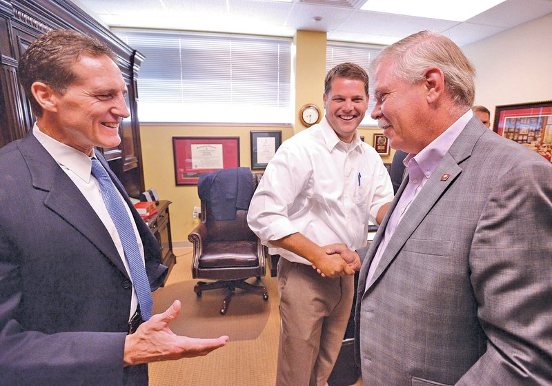 STAFF PHOTO BEN GOFF &#8226; @NWABenGoff Circuit Judge Brad Karren, from left, State Rep. Bart Hester, R-Cave Springs, and State Rep. Dan Douglas, R-Bentonville, chat Friday in Circuit Judge Tom Smith&#8217;s chambers at the Benton County Juvenile Justice Center in Bentonville.