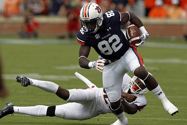 Auburn wide receiver Melvin Ray (82) catches a pass and breaks away from Arkansas safety Rohan Gaines (26) for a touchdown during the first half of an NCAA college football game on Saturday, Aug. 30, 2014, in Auburn, Ala. (AP Photo/Butch Dill)