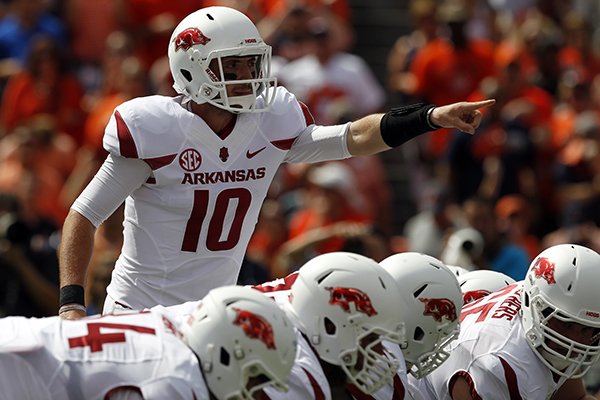 Arkansas quarterback Brandon Allen (10) signals as he walks up to the line during the first half of an NCAA college football game against Auburn on Saturday, Aug. 30, 2014, in Auburn, Ala. (AP Photo/Butch Dill)