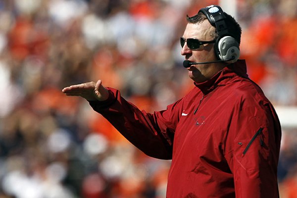 Arkansas head coach Bret Bielema signals to a players during the first half against Auburn of an NCAA college football game on Saturday, Aug. 30, 2014, in Auburn, Ala. (AP Photo/Butch Dill)