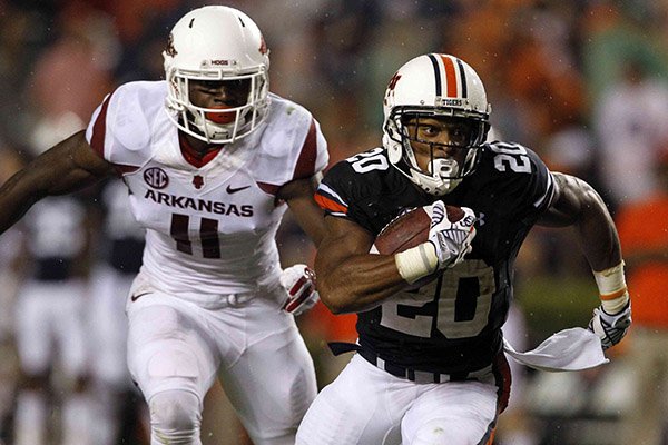 Auburn running back Corey Grant (20) breaks free from Arkansas linebacker Randy Ramsey (11) and runs for a first down during the second half of an NCAA college football game on Saturday, Aug. 30, 2014, in Auburn, Ala. Auburn defeated Arkansas 45-21. (AP Photo/Butch Dill)