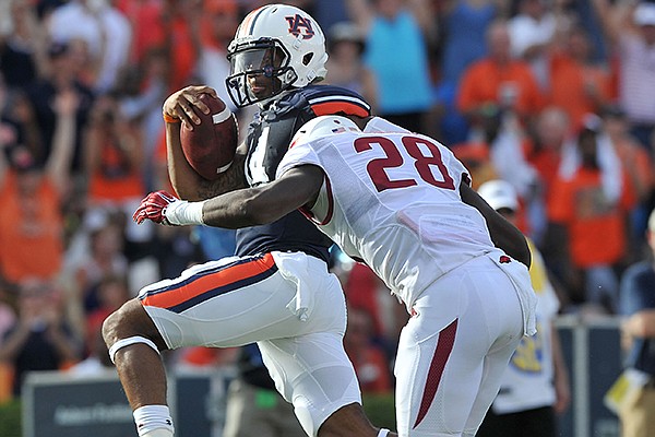 Auburn quarterback Nick Marshall pushes past Arkansas defender Josh Liddell to score a touchdown in the third quarter of a game Saturday, Aug. 30, 2014 at Jordan-Hare Stadium in Auburn, Ala.