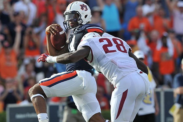 Auburn quarterback Nick Marshall pushes past Arkansas defender Josh Liddell to score a touchdown in the third quarter of a game Saturday, Aug. 30, 2014 at Jordan-Hare Stadium in Auburn, Ala.