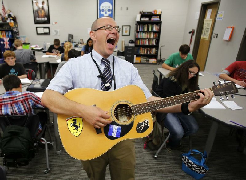 Teacher Thomas Lewandowski finishes a song during class Wednesday at Rogers New Technology High School. The school is entering its second year as a charter high school that is part of the Rogers School District.