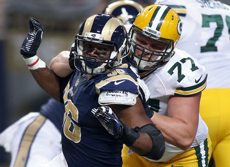 Defensive end Michael Sam (left) was released Saturday by the St. Louis Rams despite recording 11 tackles and three sacks during the preseason.