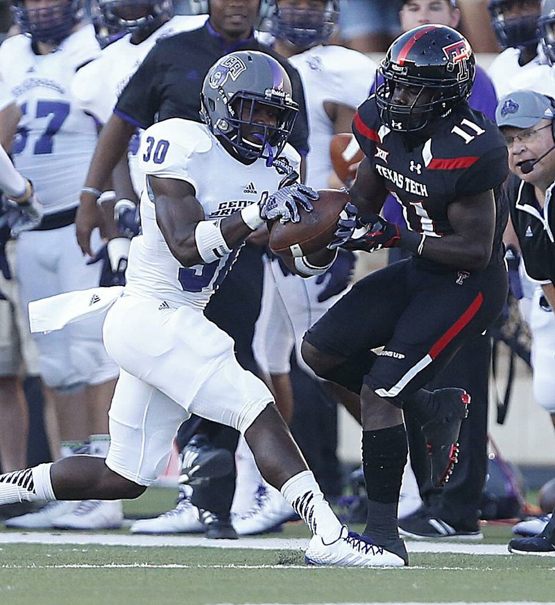 Central Arkansas’ Artez Williams (left) intercepts a pass in front of Texas Tech’s Jakeem Grant during the Bears’ 42-35 loss to the Red Raiders on Saturday in Lubbock, Texas.